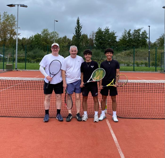 Adults and juniors together on court at the net during Adults vs Juniors 2026