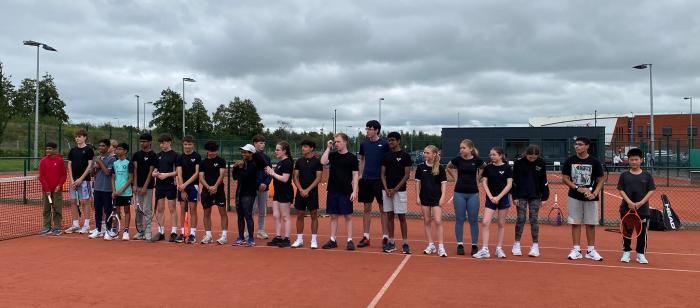 Junior players lined up on court at the Adults vs Juniors 2026 event